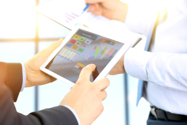istock Business colleagues working and analyzing financial figures / graphs on a digital tablet 872275314