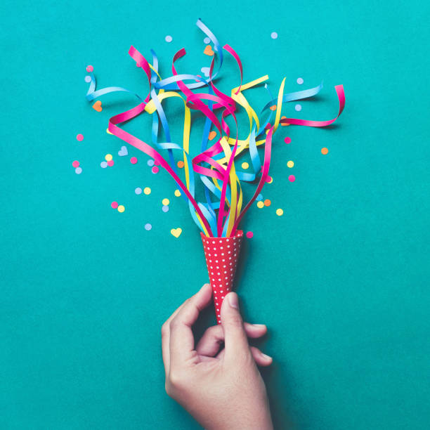 istock Celebration,party concepts.hand holding colorful confetti,streamers. 872278738