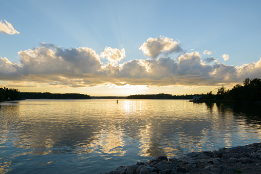 Beautiful landscape scenic shore under rays of light shining through clouds at Turku Finland in Ruissalo island horizontal shot