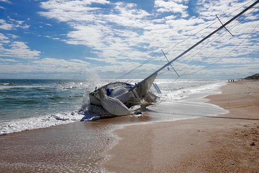 Abandoned, shipwrecked sailboat on Vilano Beach, Florida (USA) following Hurricane Irma