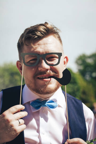 istock Groom on a Wedding Walk in the Park 872285694