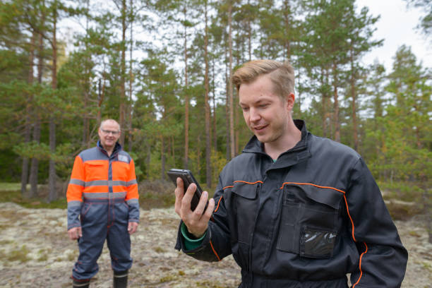 istock Mature man and young man working together in the forest 872285822