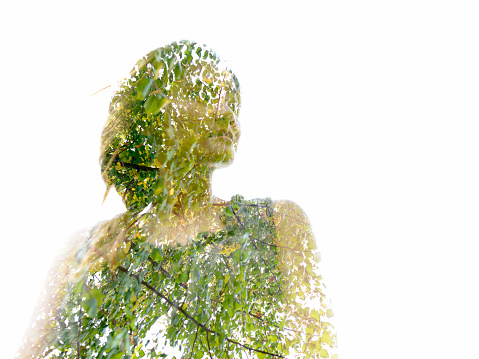 Double exposure of young woman and tree branches with autumn leaves