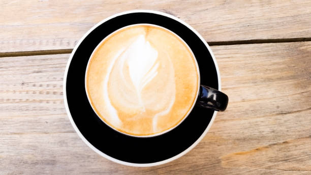 istock Close-up of cappuccino on a wooden table 872289512