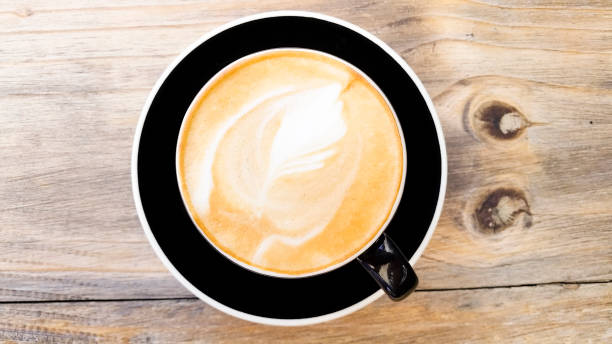 istock Close-up of cappuccino on a wooden table 872289528