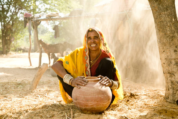 istock Indian woman holding earthen pot 872295052
