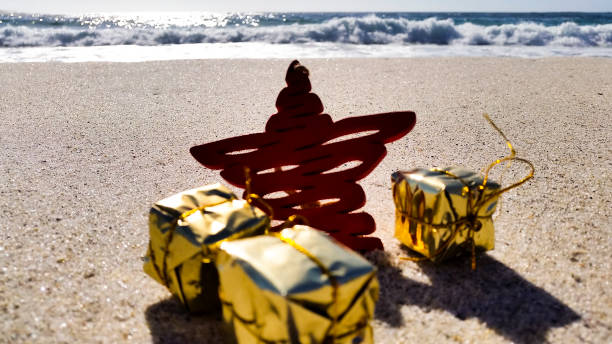 istock Christmas star with presents on the beach 872295266