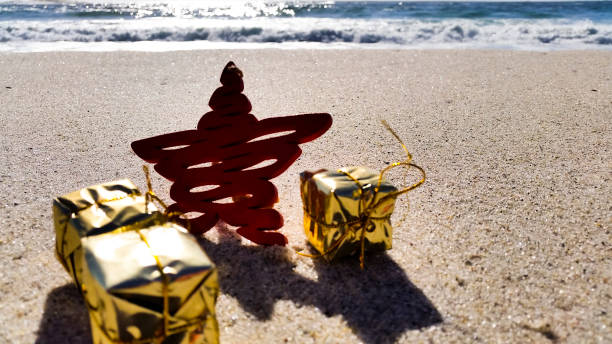 istock Christmas star with presents on the beach 872295272