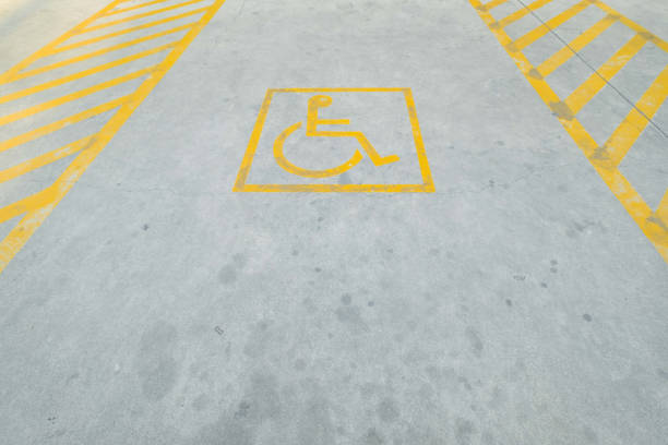 istock Yellow disable parking road sign marking on concrete. 872296214