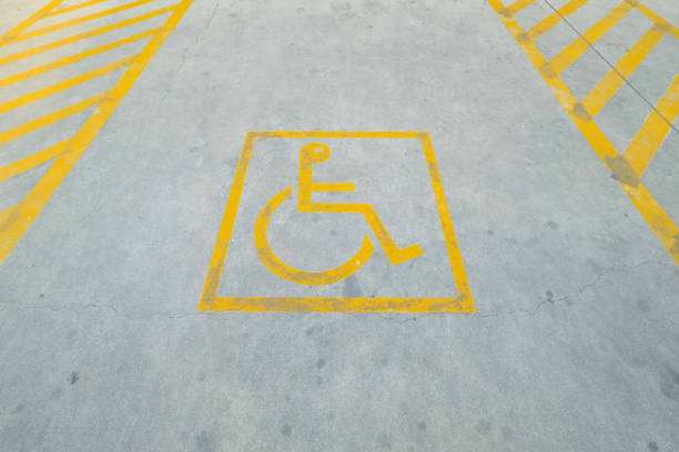 istock Yellow disable parking road sign marking on concrete. 872296290