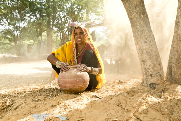 istock Indian woman holding earthen pot 872300488