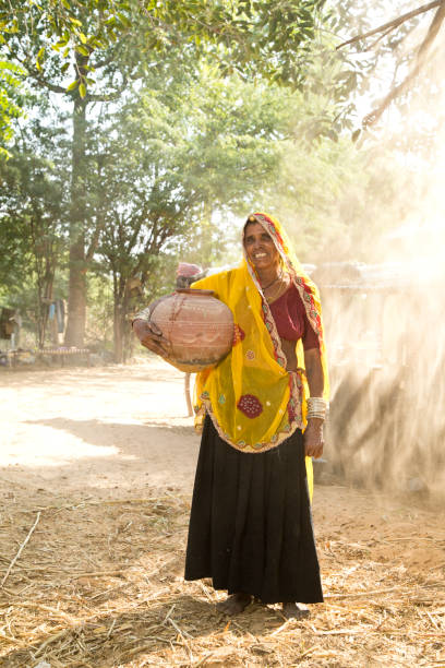istock Indian woman carrying water pot 872300536