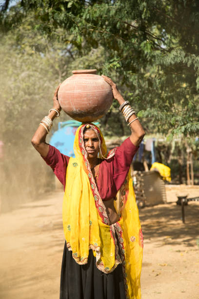 istock Indian woman carrying water pot 872300652