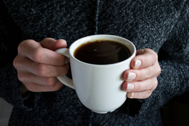 istock holding a cup of coffee 872300918