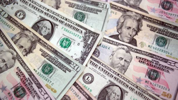 istock U.S. paper currency spread in a fan pattern. 872301536