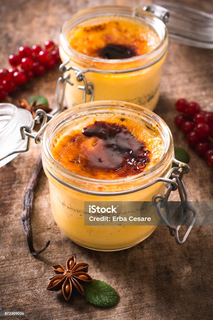 Sweet cream brulee Traditional French dessert cream brulee in jars,selective focus Baked Stock Photo