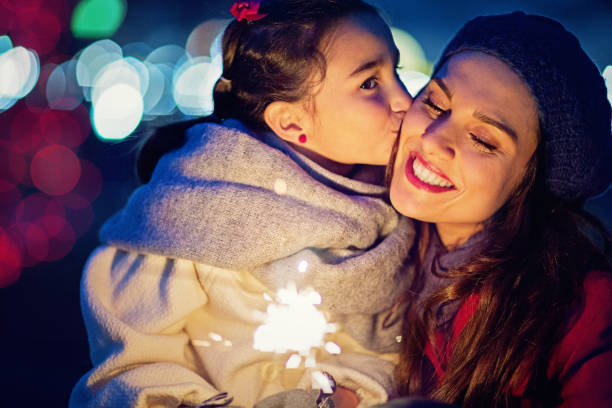 istock Daughter is kissing her mom at Christmas 872323574