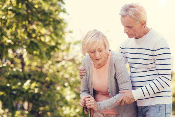 istock Pleasant caring man helping his wife 872325232
