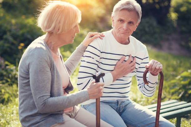 istock Nice elderly couple resting on the bench 872327812