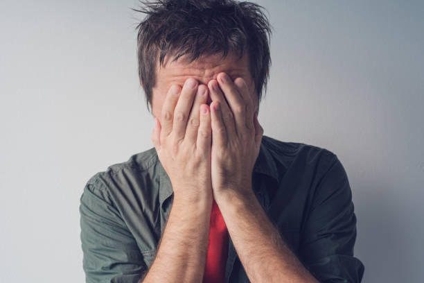 istock Disappointed man crying with head in hands 872327946