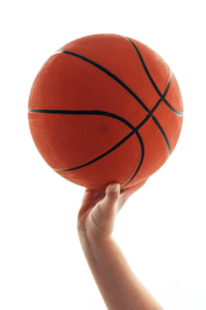 istock Female hand with basketball 872328064