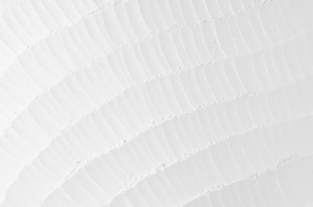 istock White abstract soft smooth striped plaster background with curved rippled waves. 872328204