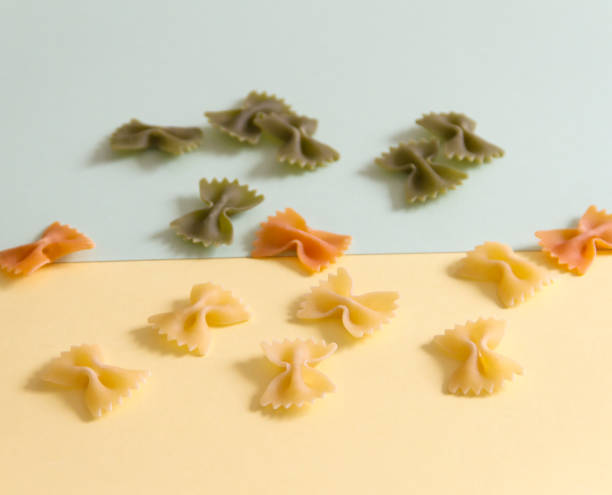 istock Raw pasta ties on a pastel colored background 872331408