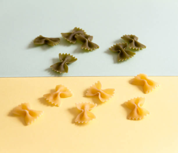 istock Raw pasta ties on a pastel colored background 872331422
