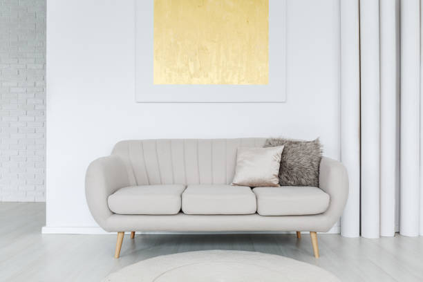 istock Gold painting above grey sofa 872331696