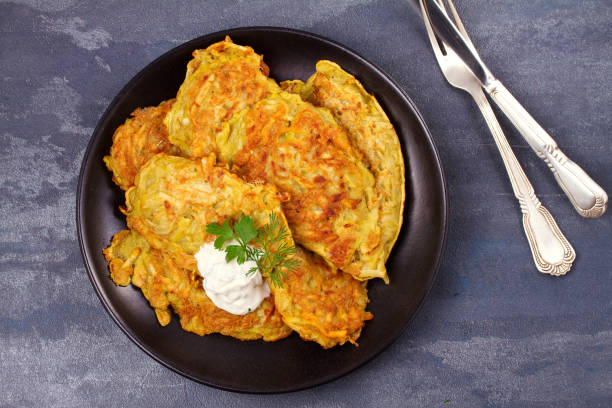 placki ziemniaczane. placki warzywne. latkes na czarnej płycie - hash brown gold food vegetable zdjęcia i obrazy z banku zdjęć