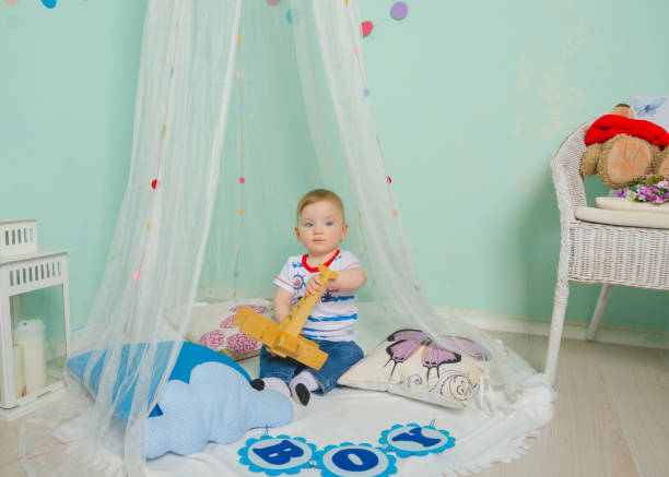 istock sitting on the floor and playing with plane boy baby 872343286