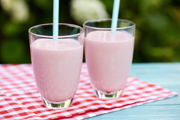 istock Strawberry milkshake on wooden background 872349340