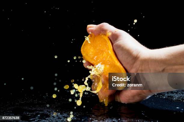 Squeezing Orange Stock Photo - Download Image Now - Squeezing, Orange - Fruit, Orange Color