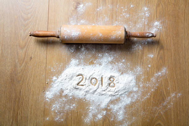 istock New Year with conceptual rolling pin, 2018 written in flour 872361282