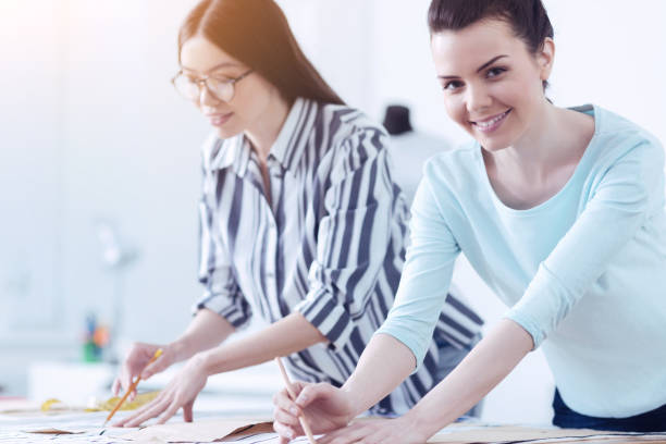 istock Young smiling tailors at their workplace in the atelier 872364308