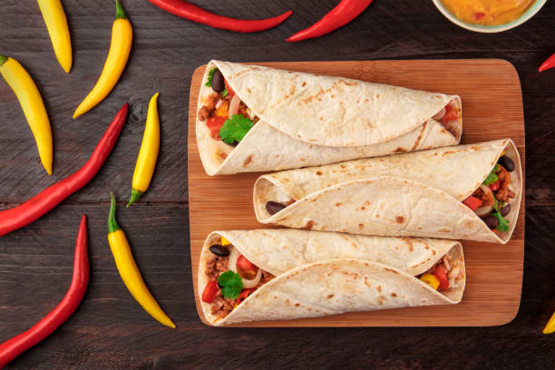 istock Mexican burritos with cheese salsa, and chili peppers 872368794