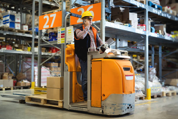 istock Man with clipboard and smartphone at warehouse 872368832