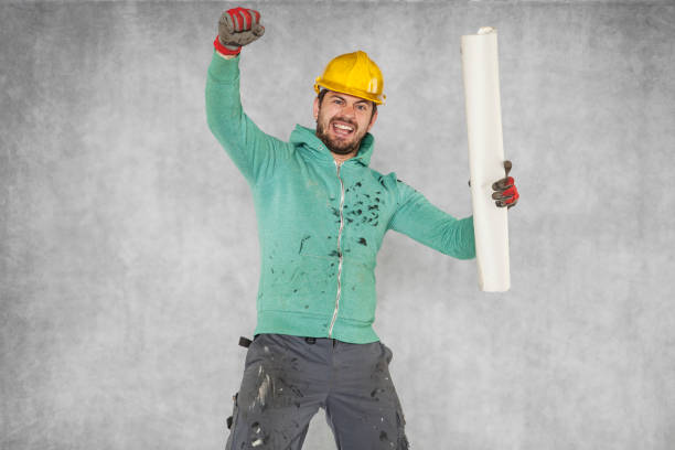 istock investor delight, construction plans in hand 872369566