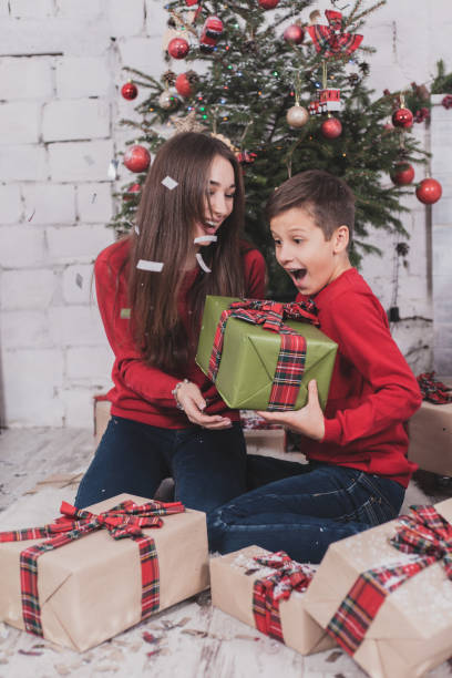 istock Girl and boy christmas with presents in hands 872374380