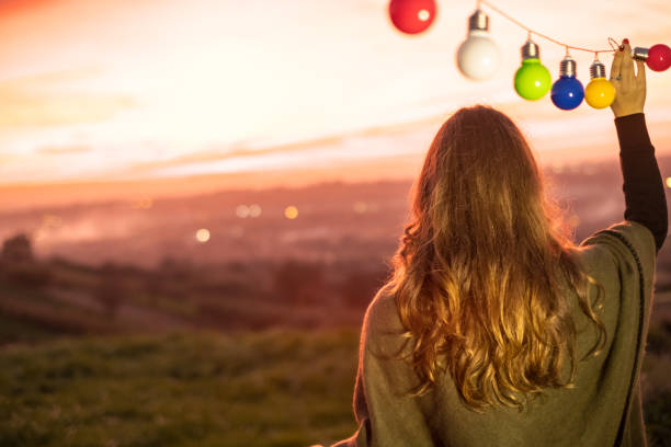 istock Young girl and colorful lightbulbs 872377838
