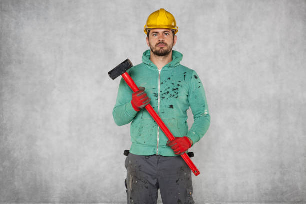 istock worker with a big hammer, portrait 872378472