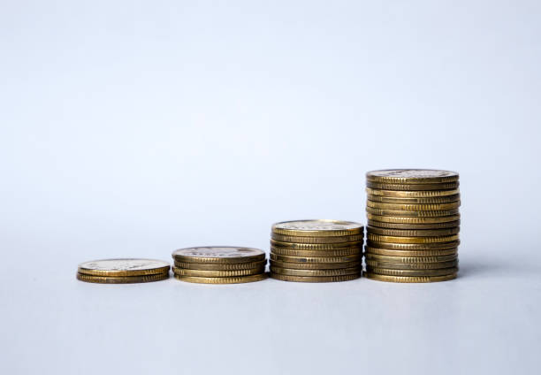 istock Growing stacks of coins against white background. Saving money concept. 872378540