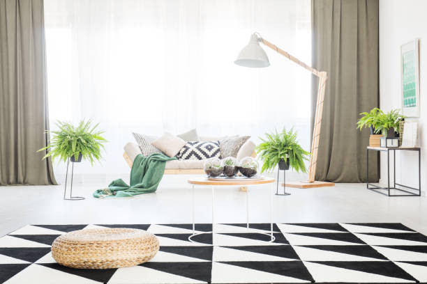 istock Spacious living room with pouf 872385328