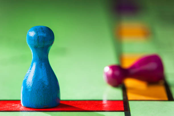 istock Blue pawn winner and a purple pawn loser 872386510