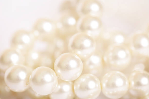 istock Pile of pearls on the white background 872386676