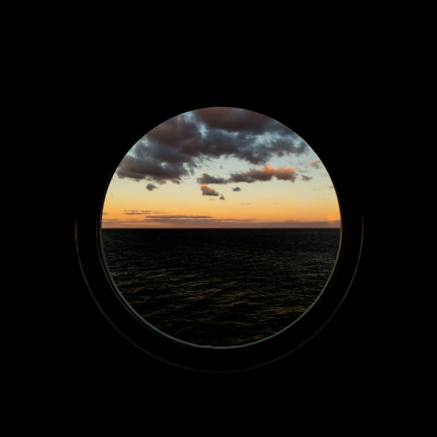 istock view through porthole on dawn at sea with clouds 872388920