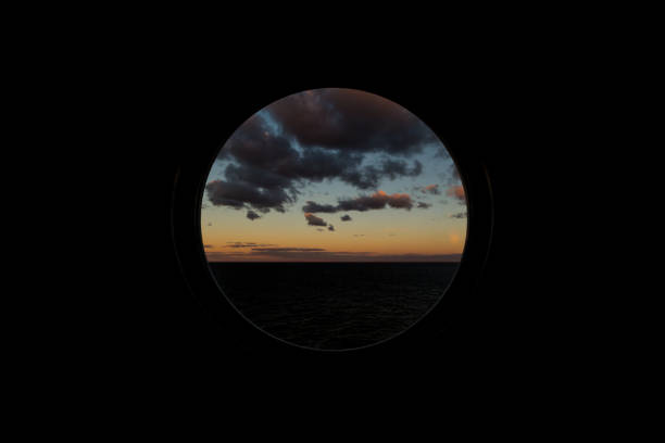 istock view through round porthole scuttle on dawn at sea 872388980
