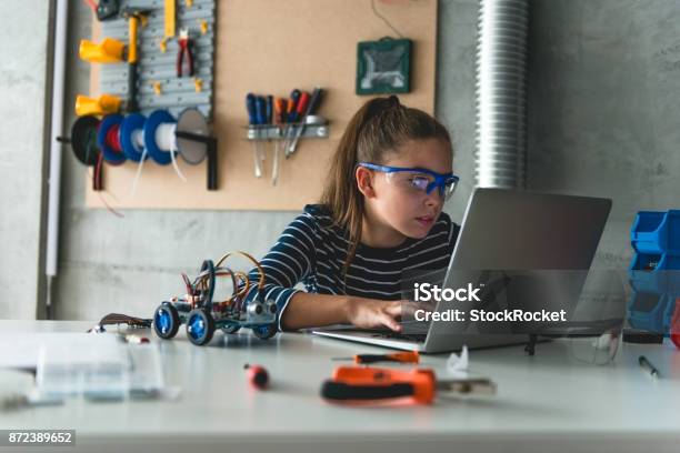 Working On Laptop For School Assignment Stock Photo - Download Image Now - Child, Building - Activity, Robot