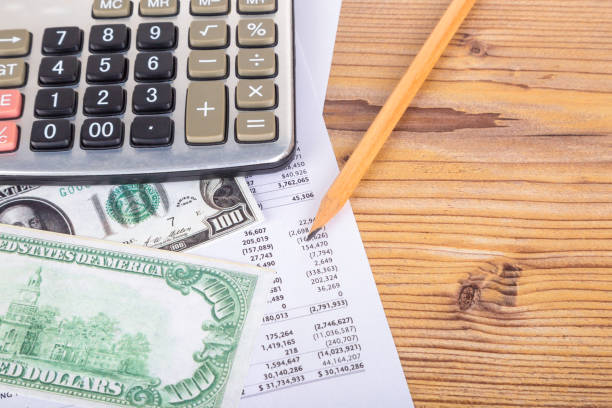 istock Dollar Banknotes with Pencil and Calculator on Earning Report 872389972