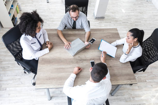 istock High angle view of team working in office 872390144